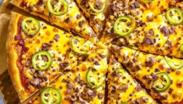 Spicy Birria Pizza Recipe: The Ultimate Fusion of Flavors For the Birria Pizza Recipe image, if you're looking for an alt text, title, and description with a focus on SEO (similar to the Marry Me Chicken), here it is: Alt Text: Close-up of a sliced Birria Pizza on a wooden board, topped with melted cheese, shredded birria meat, and vibrant green jalapeño slices, sprinkled with chili flakes.