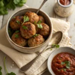 Turkey Meatballs in Bowl. Healthy and flavorful turkey meatballs served with marinara sauce and garnished with parsley.