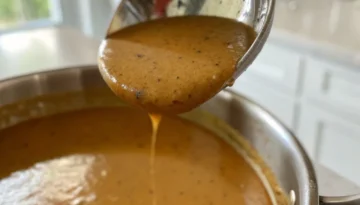 Perfect Homemade Gravy - Easy Recipe Guide Creamy homemade gravy being ladled.
