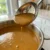 Creamy homemade gravy being ladled.